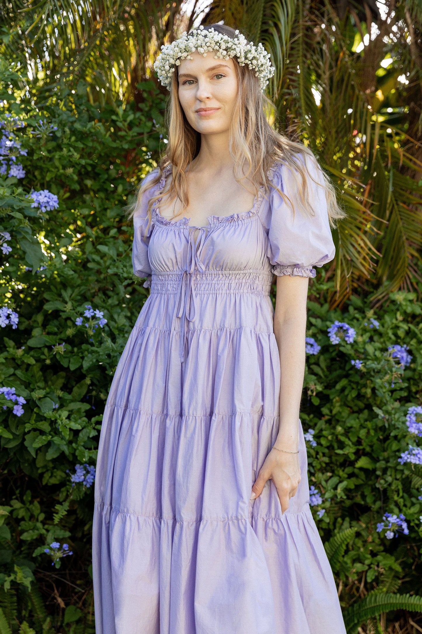 Model wears Penelope Midi Dress Lilac in secret garden