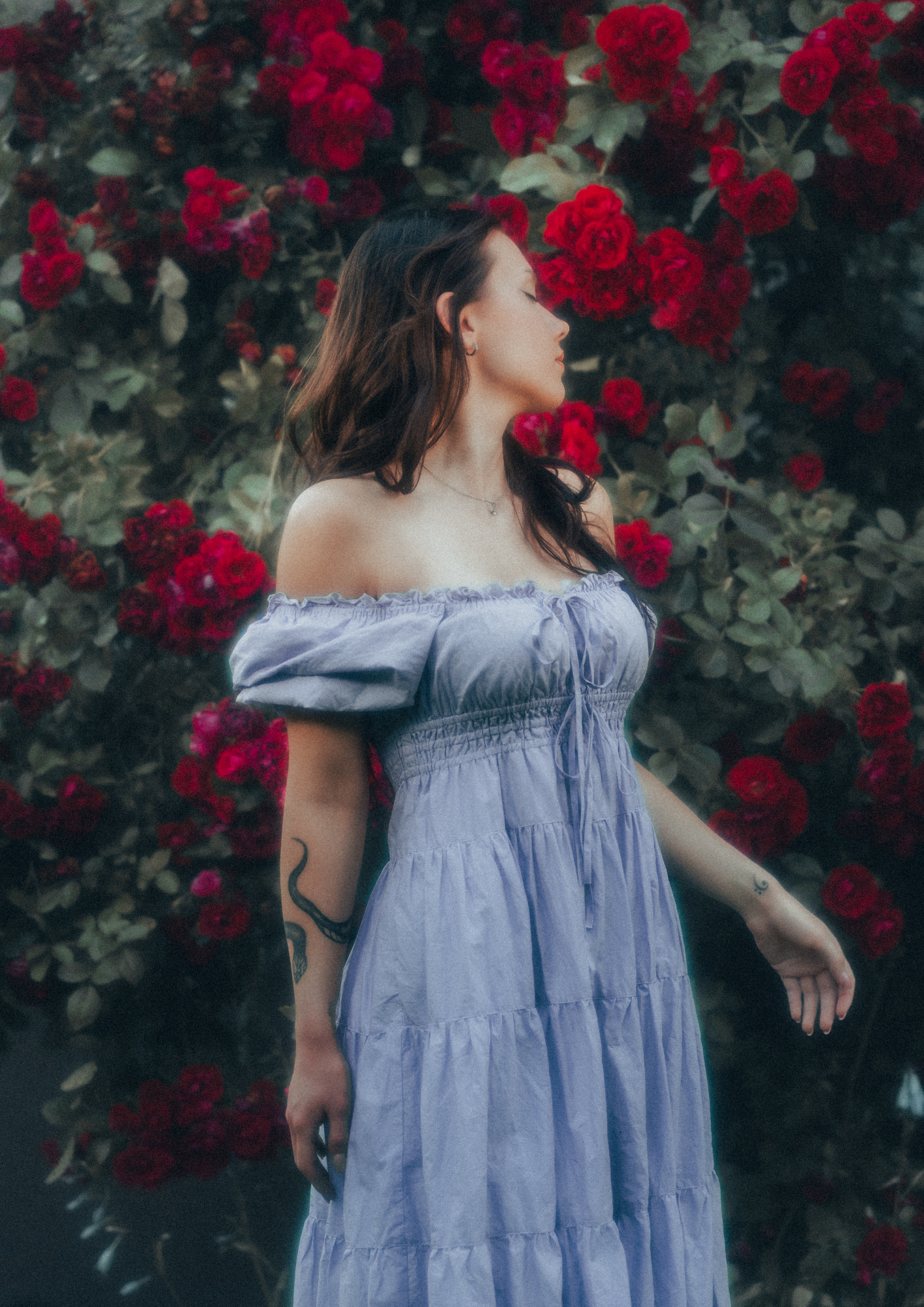 MODEL WEARS ERAVELA PENELOPE MIDI DRESS LILAC IN ENCHANTED ROSE GARDEN
