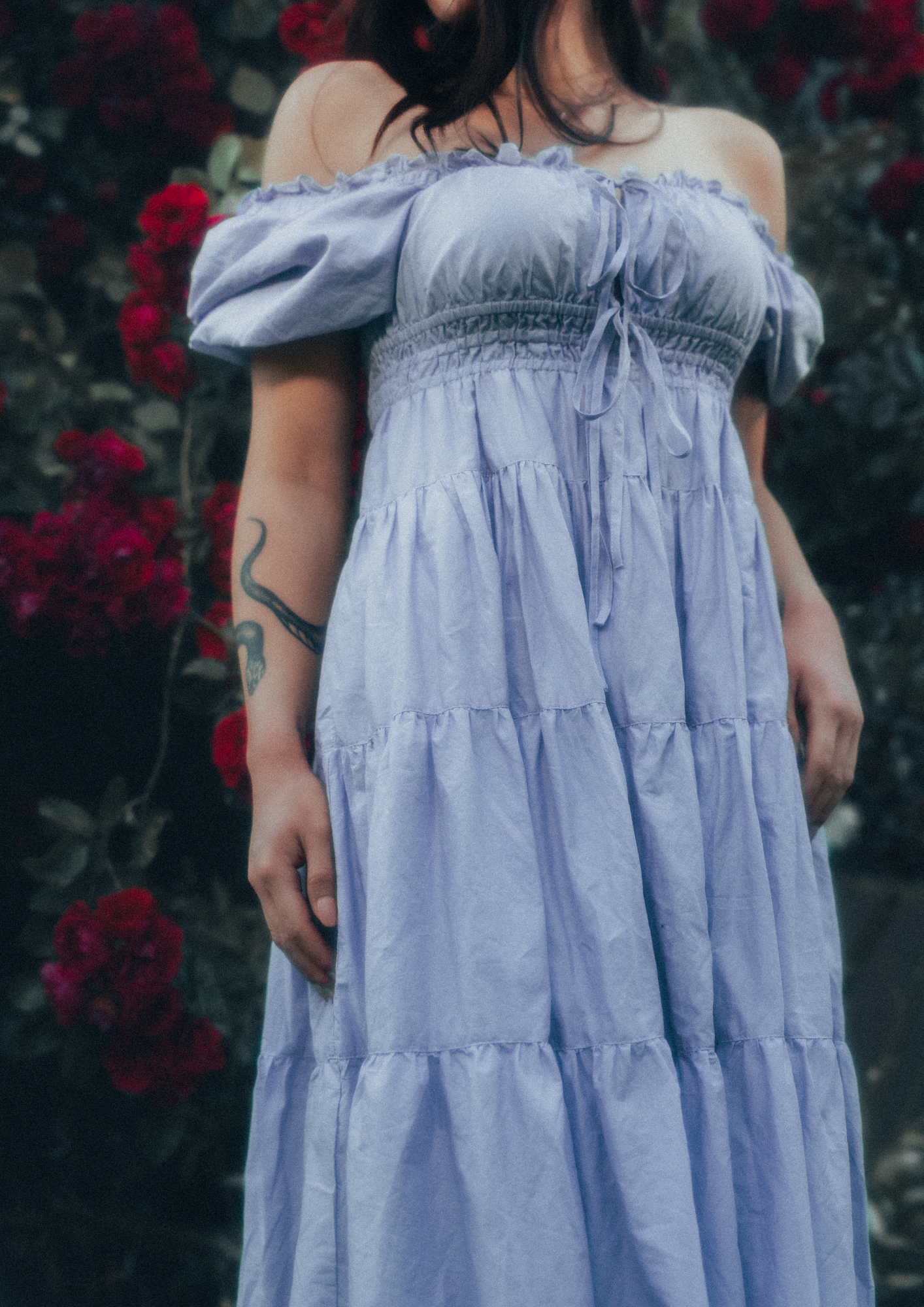 MODEL WEARS ERAVELA PENELOPE MIDI DRESS LILAC IN ENCHANTED ROSE GARDEN
